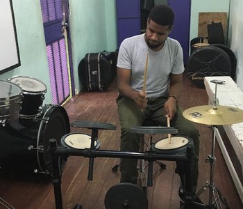 Trying out the Practice Drum Kit Donated to the Academy